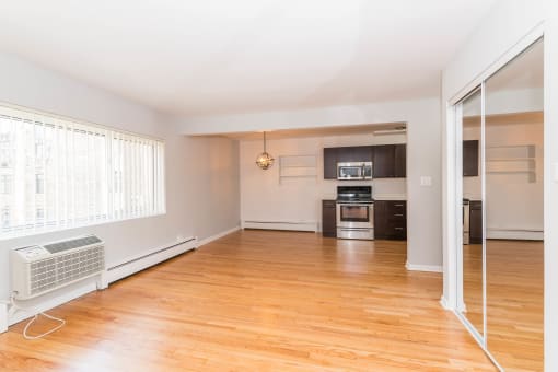 a living room with hardwood floors and a large window
