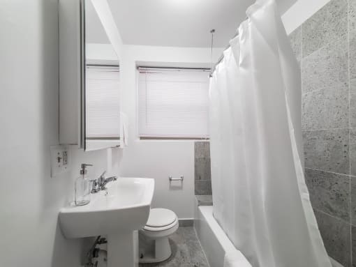a bathroom with a sink toilet and bathtub