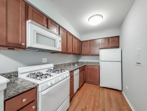 a kitchen with brown cabinets and white appliances