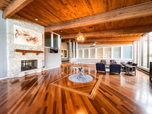 A living room with a fireplace and a painting on the wall.