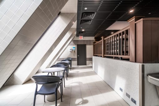 a row of tables and chairs in a corridor