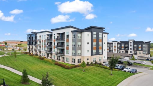 an aerial view of an apartment building with a green lawn