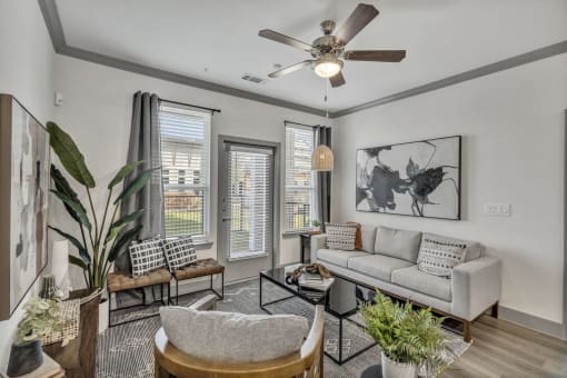 a living room with a couch and a ceiling fan