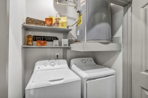a small laundry room with two washes and a dryer