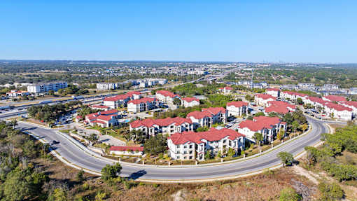 an aerial view of a city with houses and a highway