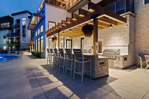 a row of bar stools in front of a building