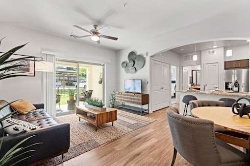 a living room with furniture and a ceiling fan