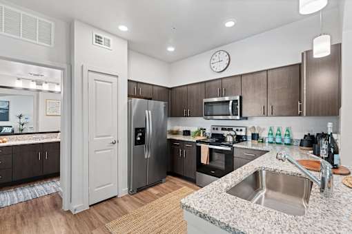 a kitchen with stainless steel appliances and granite counter tops