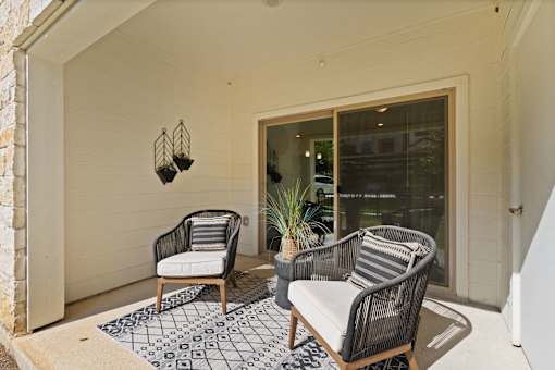 two black and white chairs on a porch