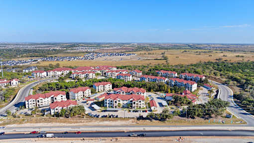 an aerial view of a city with houses and a highway