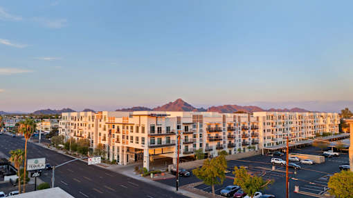 an aerial view of an apartment complex with mountains in the background