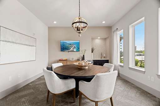 A modern dining room with a wooden table and chairs.
