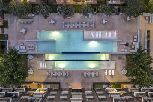 an overhead view of a building with a pool in the middle of it
