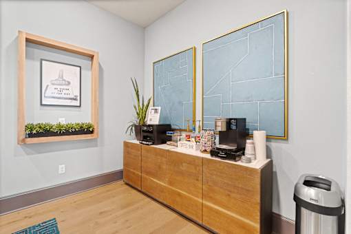 a reception area with a wooden dresser and a coffee machine on top of it