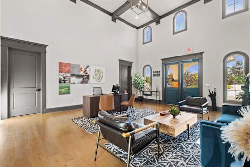 a living room with couches and chairs and a table