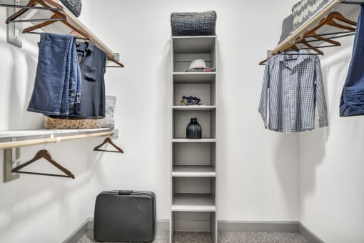 a small walk in closet with a ladder and shelves