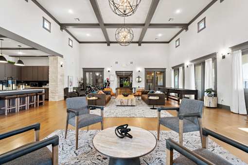 a large living room with furniture and a kitchen