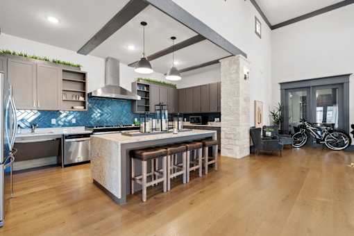a kitchen with a large island with stools in front of it
