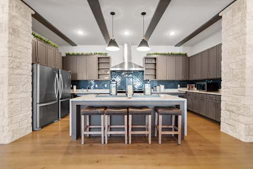 a large kitchen with a center island and stainless steel appliances