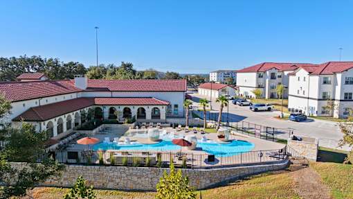 an aerial view of a swimming pool in front of a building
