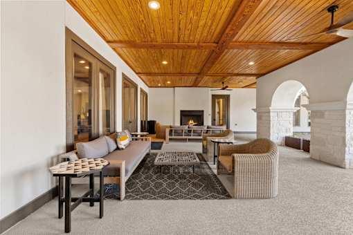 a living room with couches and chairs and a fireplace
