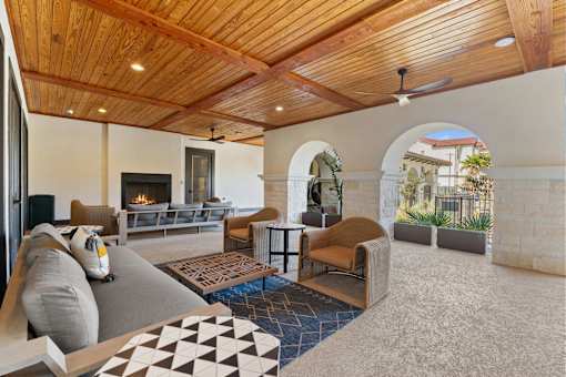 a living room with couches and chairs and a fireplace
