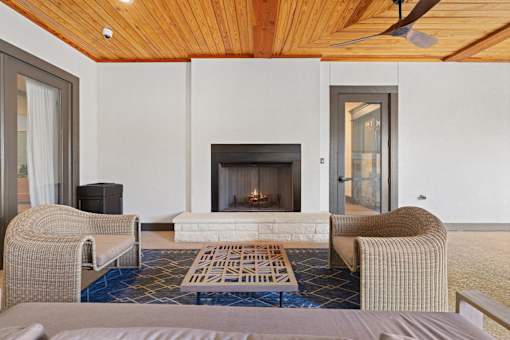 a living room with two chairs and a fireplace