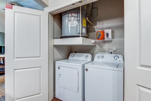 a washer and dryer in a closet next to a door