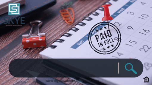 A red binder clip is on a notebook with a "Paid in Full" stamp.