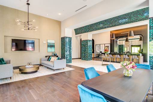 A modern dining room with a wooden table and blue chairs.