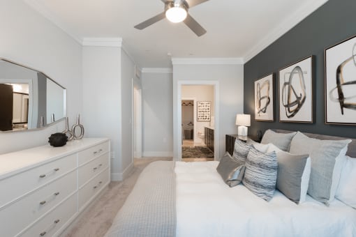 a bedroom with a bed and a ceiling fan