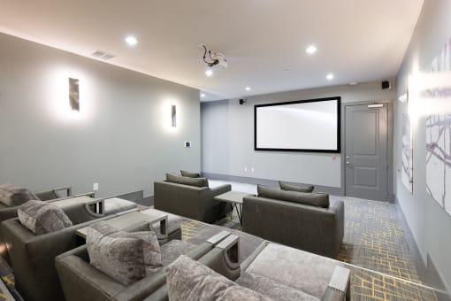 a large screening room with couches and a projector