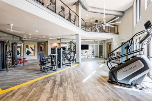 a spacious fitness center with treadmills and other exercise equipment