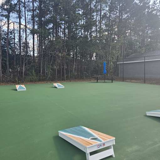 A table tennis court with a green surface and a white table tennis table.