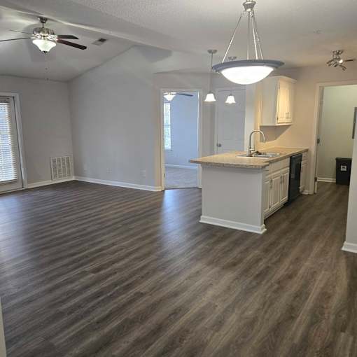 A kitchen with a countertop and a fan.