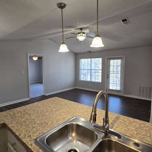 A kitchen with a sink and a ceiling fan.