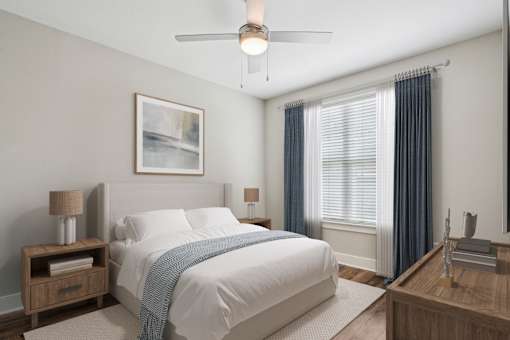 A bedroom with a large bed and a ceiling fan at Highline Urban Lofts Apartments, Cypress 77429