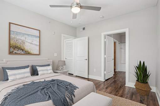 A bedroom with a bed, a ceiling fan, and a painting on the wall at Highline Urban Lofts Apartments, Cypress