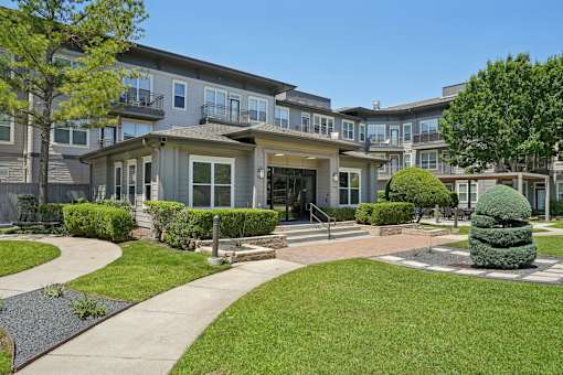 A large grassy area in front of apartment buildings at Highline Urban Lofts Apartments, Cypress, Texas