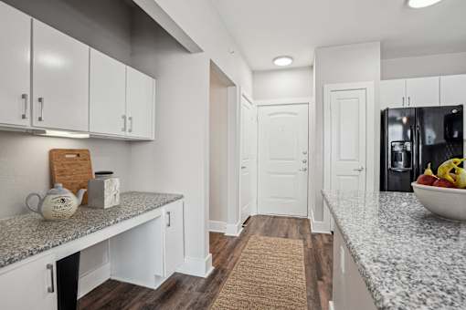 A kitchen with white cabinets and a granite countertop at Highline Urban Lofts Apartments, Texas, 77429