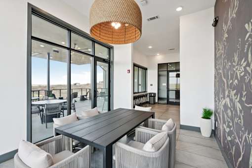 A modern dining room with a large table and chairs.