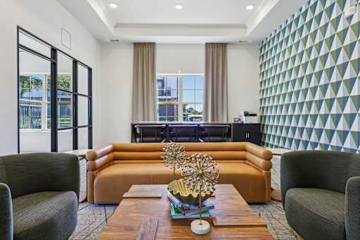 living room with a brown sofa at Vine + Vail Townhomes and Apartments, Texas