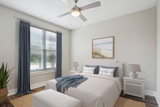 A bedroom with a large bed and a ceiling fan at Highline Urban Lofts Apartments, Cypress, TX