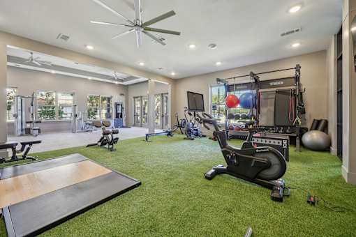 Gym wit green floor at Vine + Vail Townhomes and Apartments, Grapevine