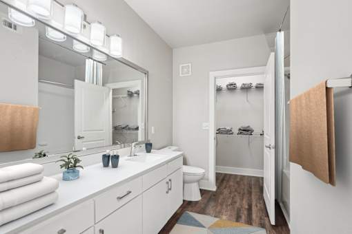 A bathroom with a white counter top and a white toilet at Highline Urban Lofts Apartments, Cypress