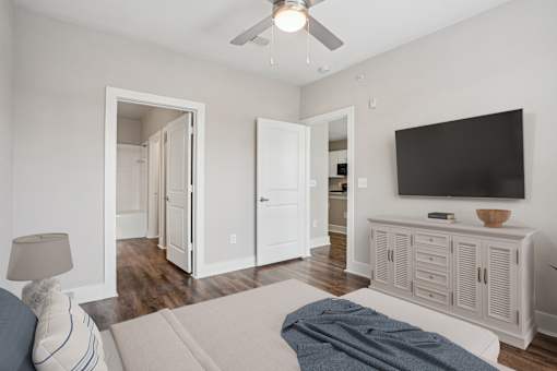 A living room with a television and a couch at Highline Urban Lofts Apartments, Cypress 77429