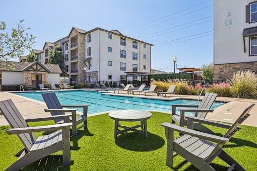 poolside area with chairs at Vine + Vail Townhomes and Apartments, Texas, 76051