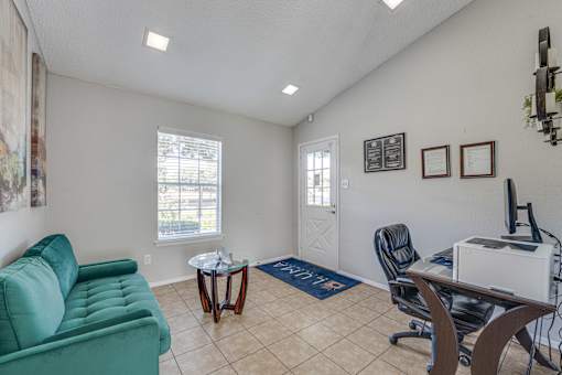 Professional office space with desk and seating at Arbors Of Cleburne Apartments, Cleburne, Texas