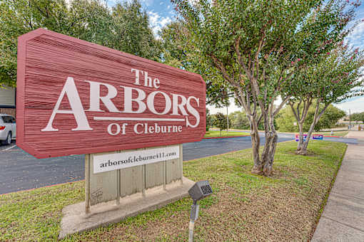 Property entrance monument sign with landscaping at Arbors Of Cleburne Apartments, Cleburne, TX
