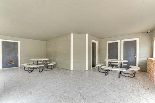 Covered picnic area with multiple tables at Arbors Of Corsicana Apartments, Texas